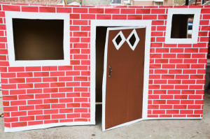 Cardboard box playhouse - trim door with white tape