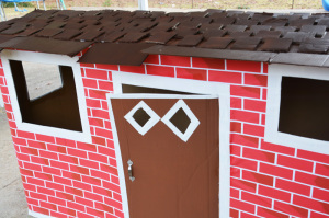 Cardboard box playhouse - shingles almost done