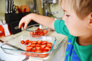 Helping arrange strawberries