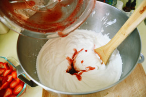 Mixing cream with strawberry syrup